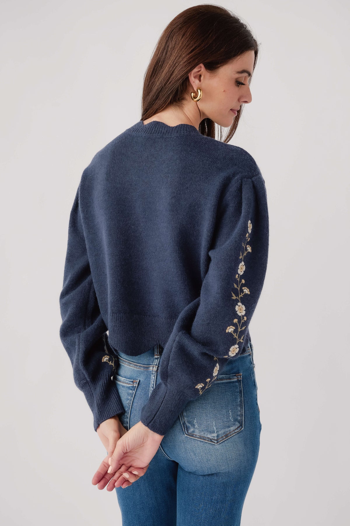 Navy embroidered sweater with floral vine trim on sleeves