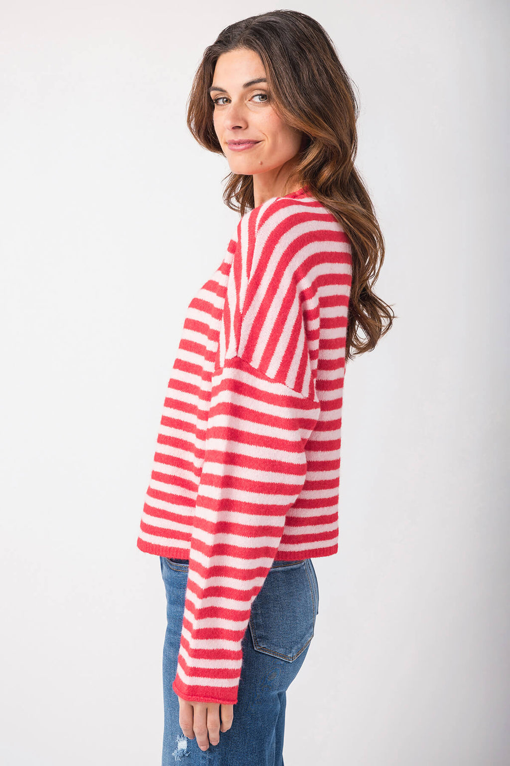 Red-and-white striped button-front cardigan with long sleeves, side profile