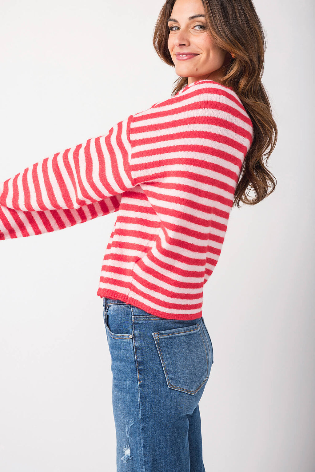 Red-and-white striped cardigan with button placket and long sleeves, side view