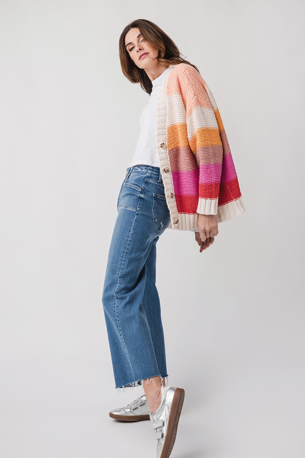 Medium wash ankle flare jeans with straight-to-flared legs and cuff fringe