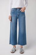 Medium wash ankle flare jeans with diagonal front pockets and button closure
