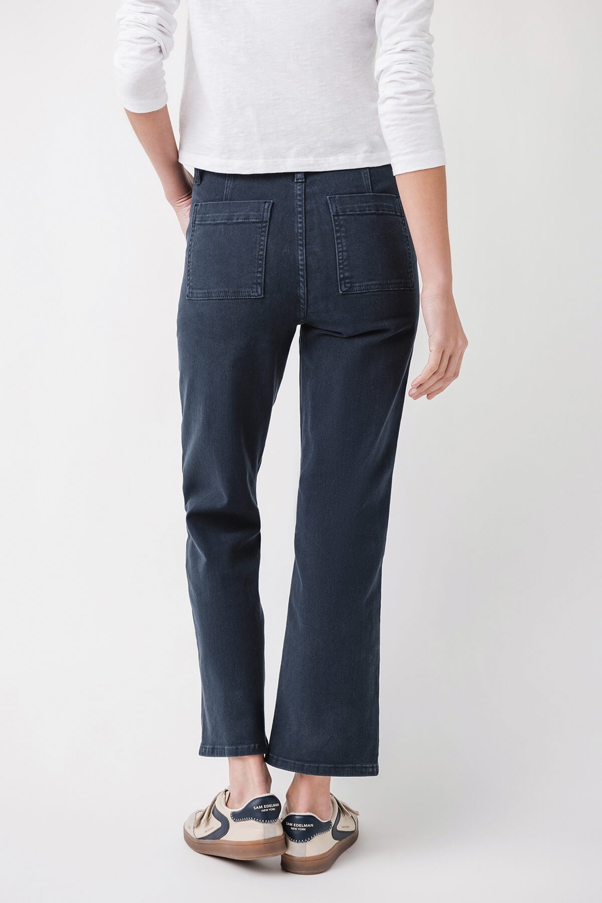 Dark blue ankle flare jeans, back view with yoke seam and patch pockets