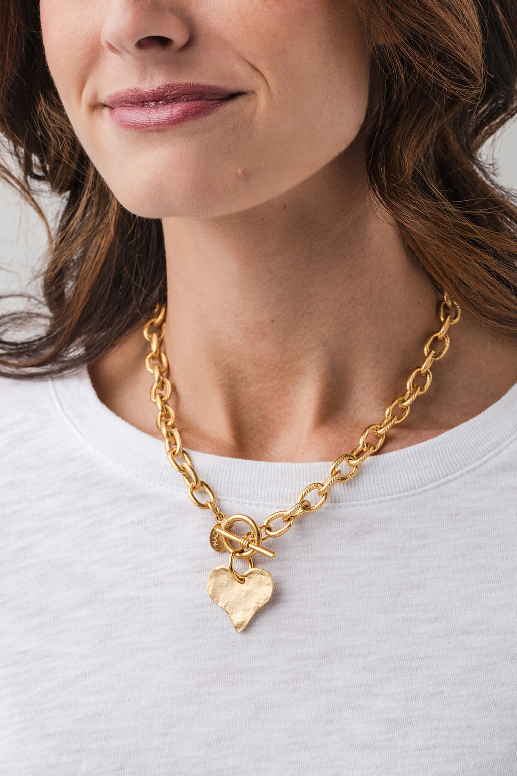 Gold toggle heart necklace on model, chunky linked chain with heart pendant