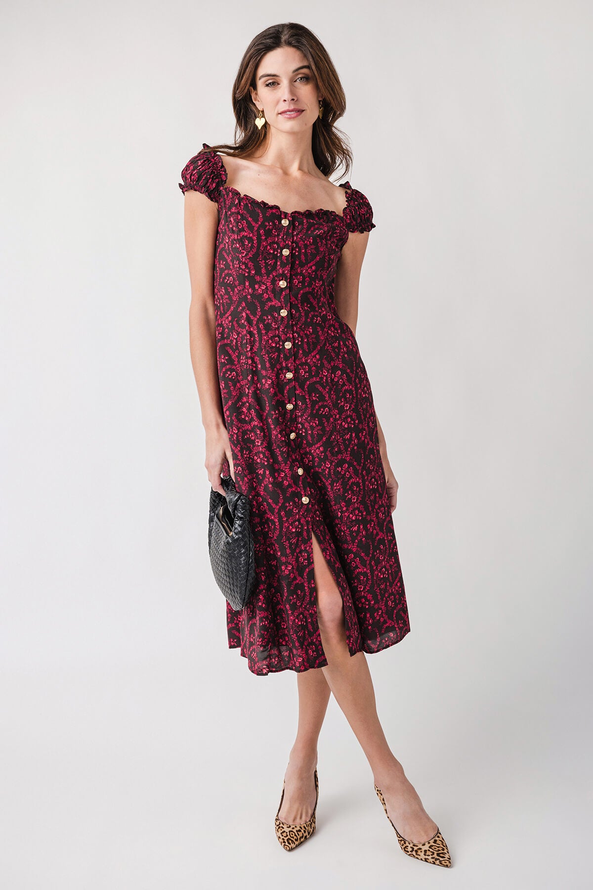 Red patterned midi dress with button-front detail, puff shoulders, and front slit