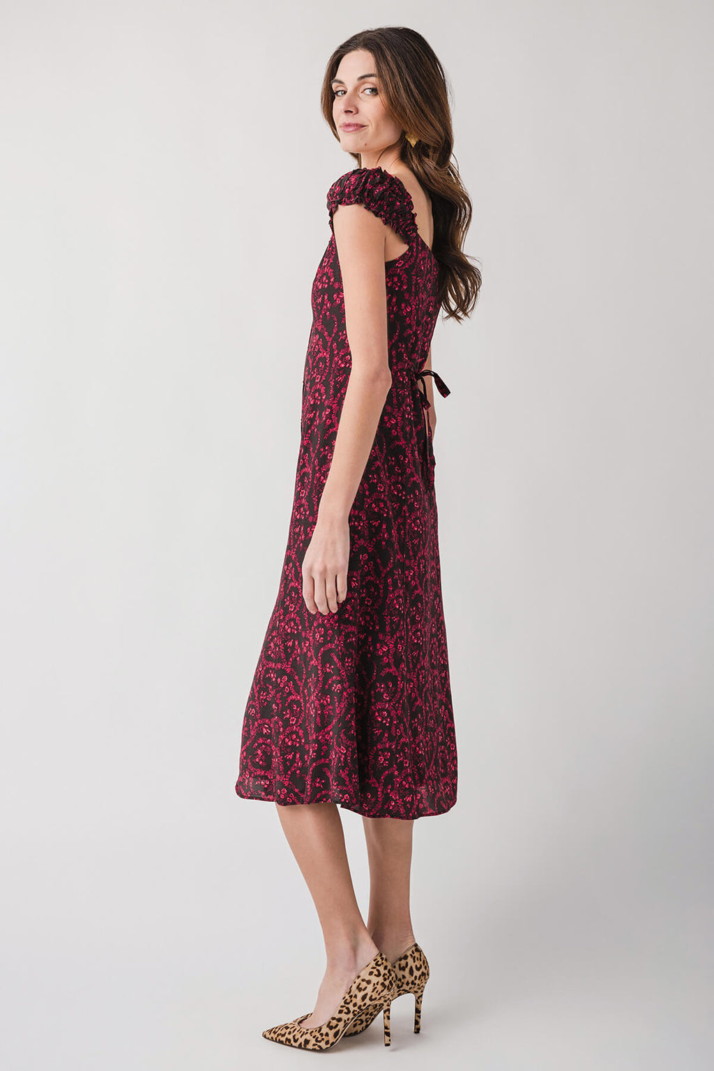 Side view red patterned midi dress with cap sleeves and fitted waist