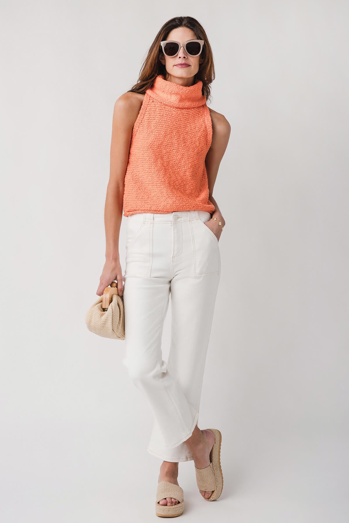 Coral sleeveless knit top with draped cowl neckline and relaxed fit