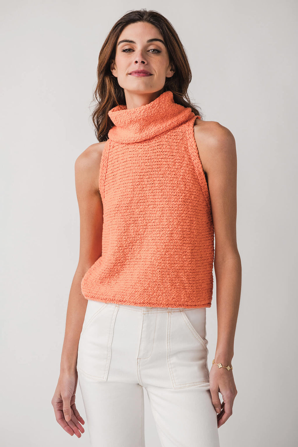 Coral sleeveless knit top with high cowl neck and textured fabric