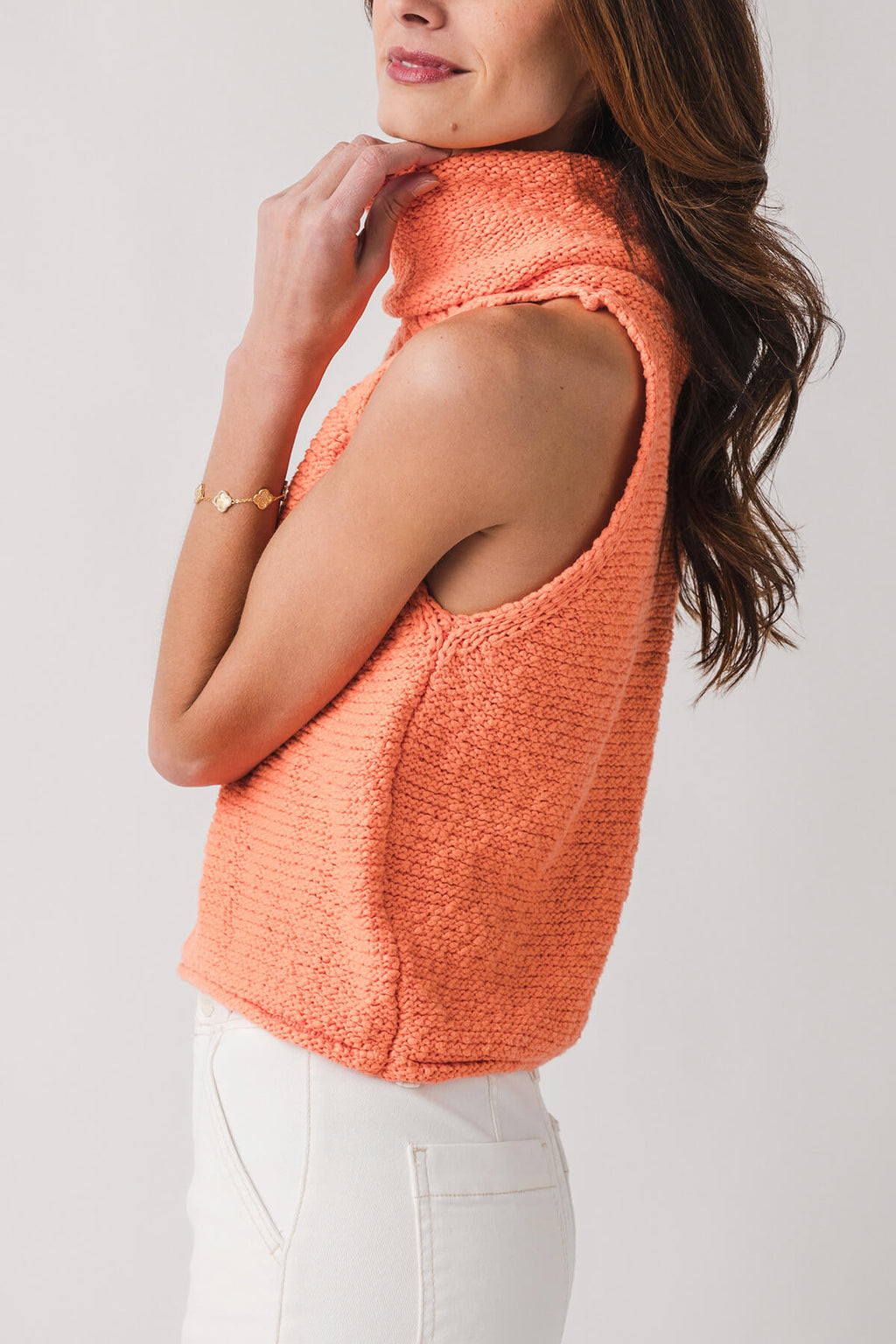 Coral sleeveless knit top with draped cowl collar and open armholes