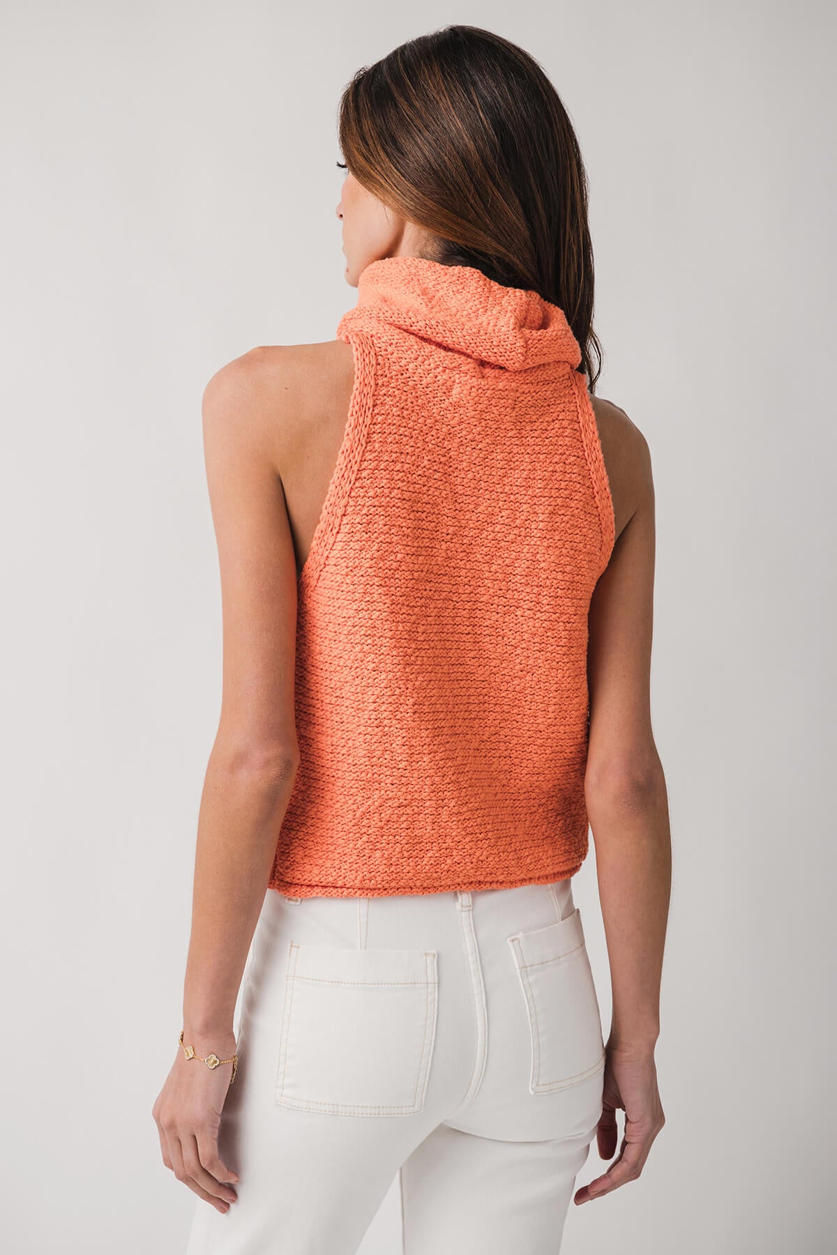 Coral sleeveless knit top from back view with cowl neck detail
