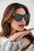 Black polarized sunglasses with dark lenses, wide square frames