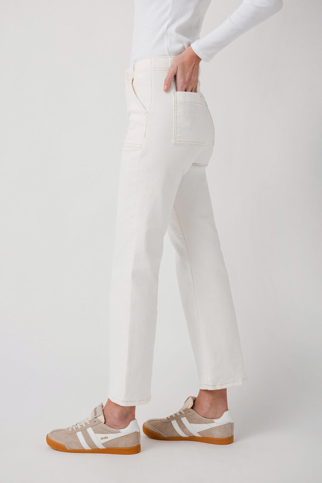 White ankle flare jeans with front pockets and belt loops, back view