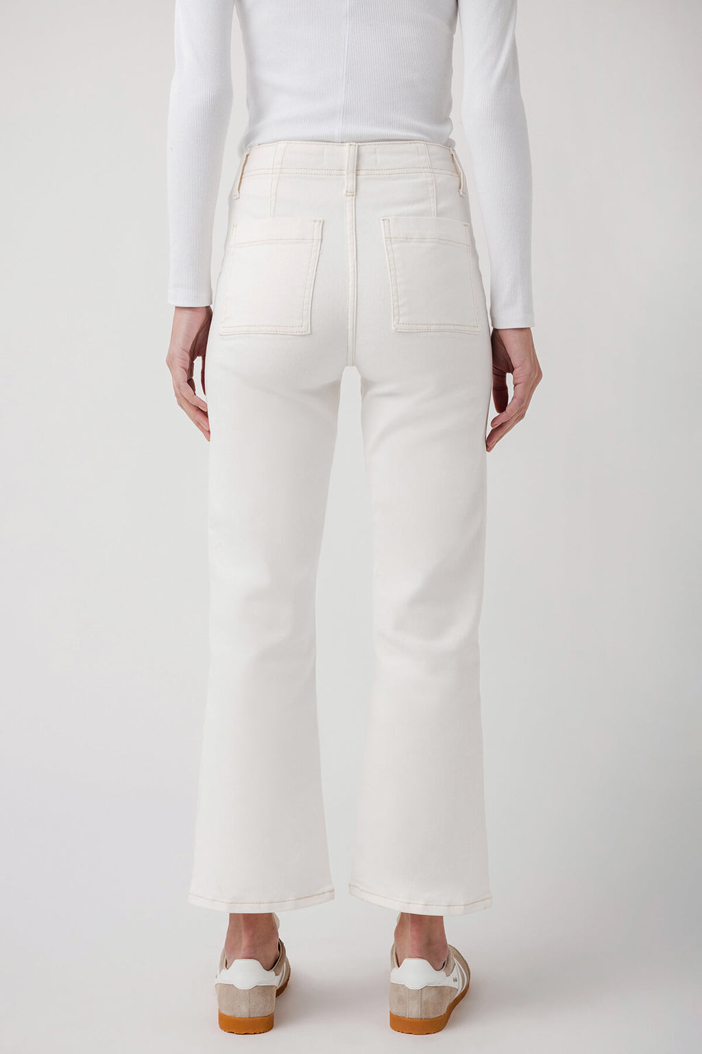 White ankle flare jeans with back yoke and pockets, straight leg opening at ankle