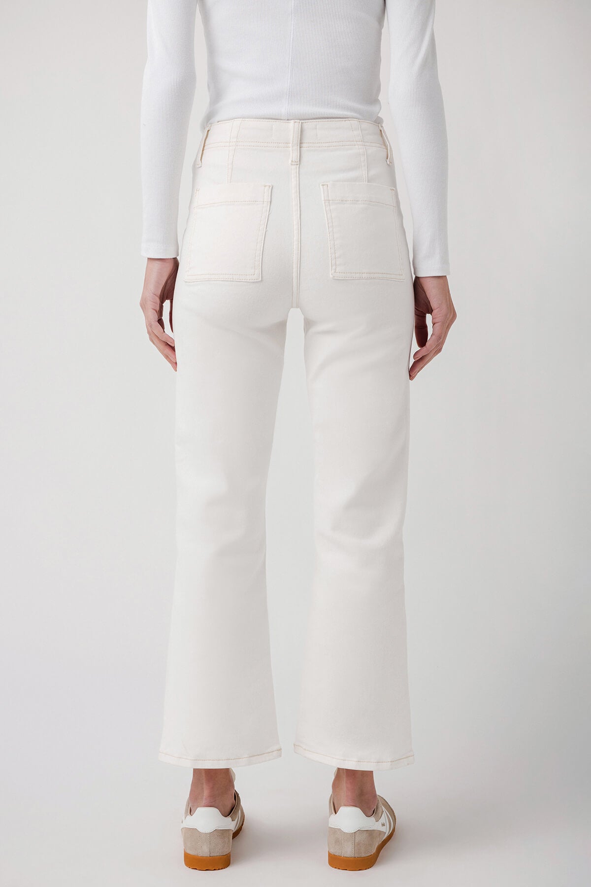 White ankle flare jeans with back yoke and pockets, straight leg opening at ankle