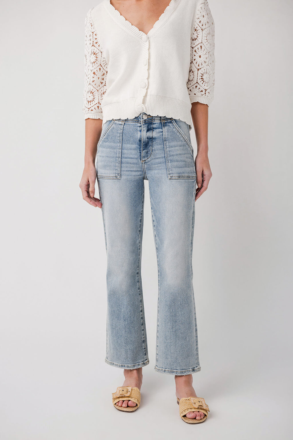 Light wash denim ankle flare jeans with button closure and five-pocket design, front view