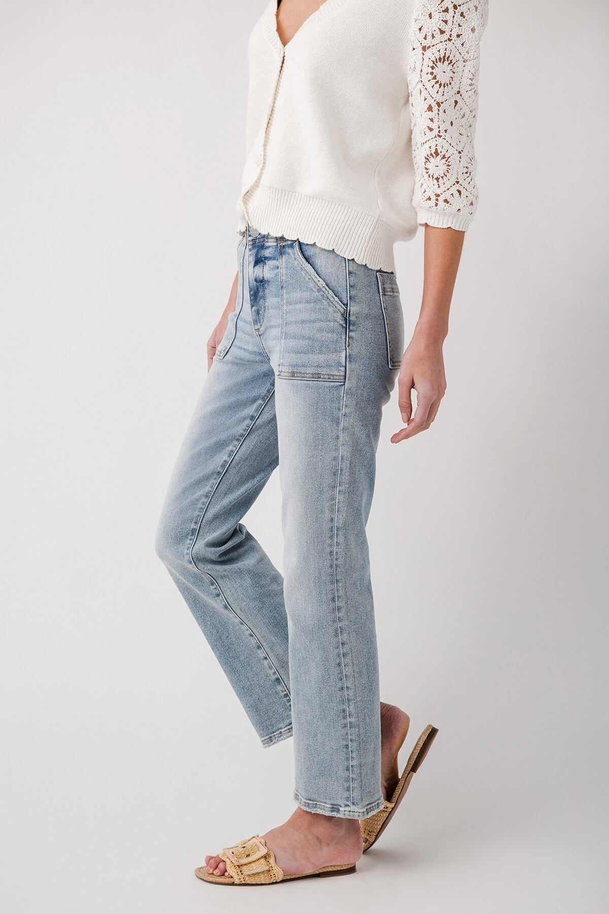 Light blue ankle flare jeans with five-pocket styling and stitched seams, side view