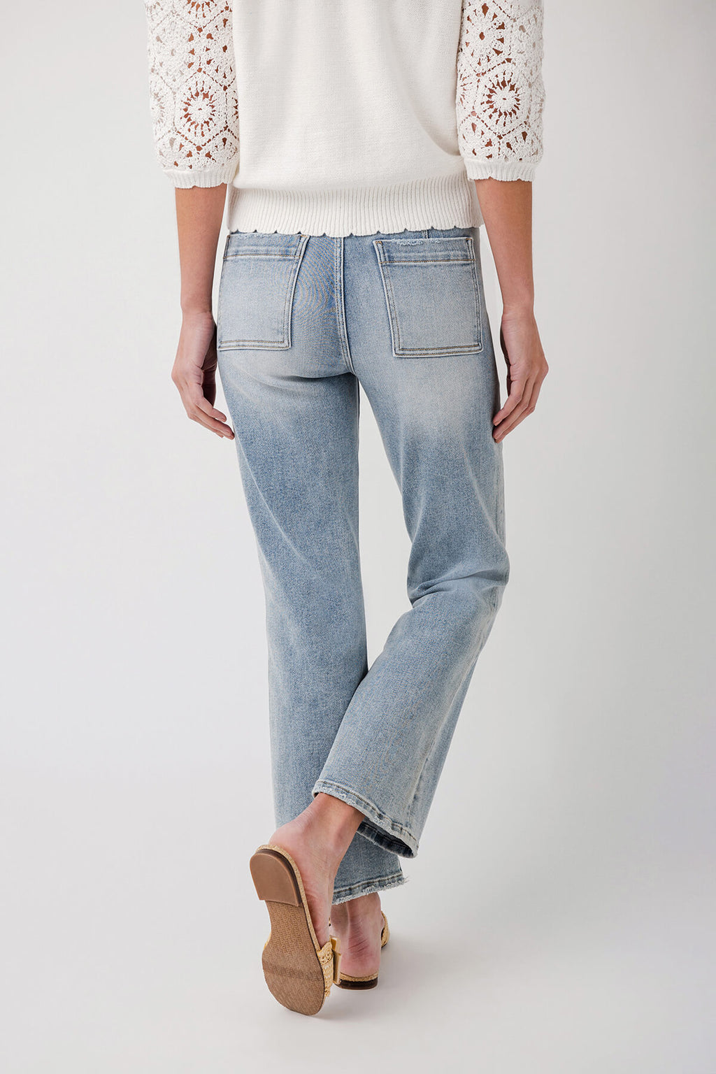 Light blue ankle flare jeans with button fly and stitched front patch pockets