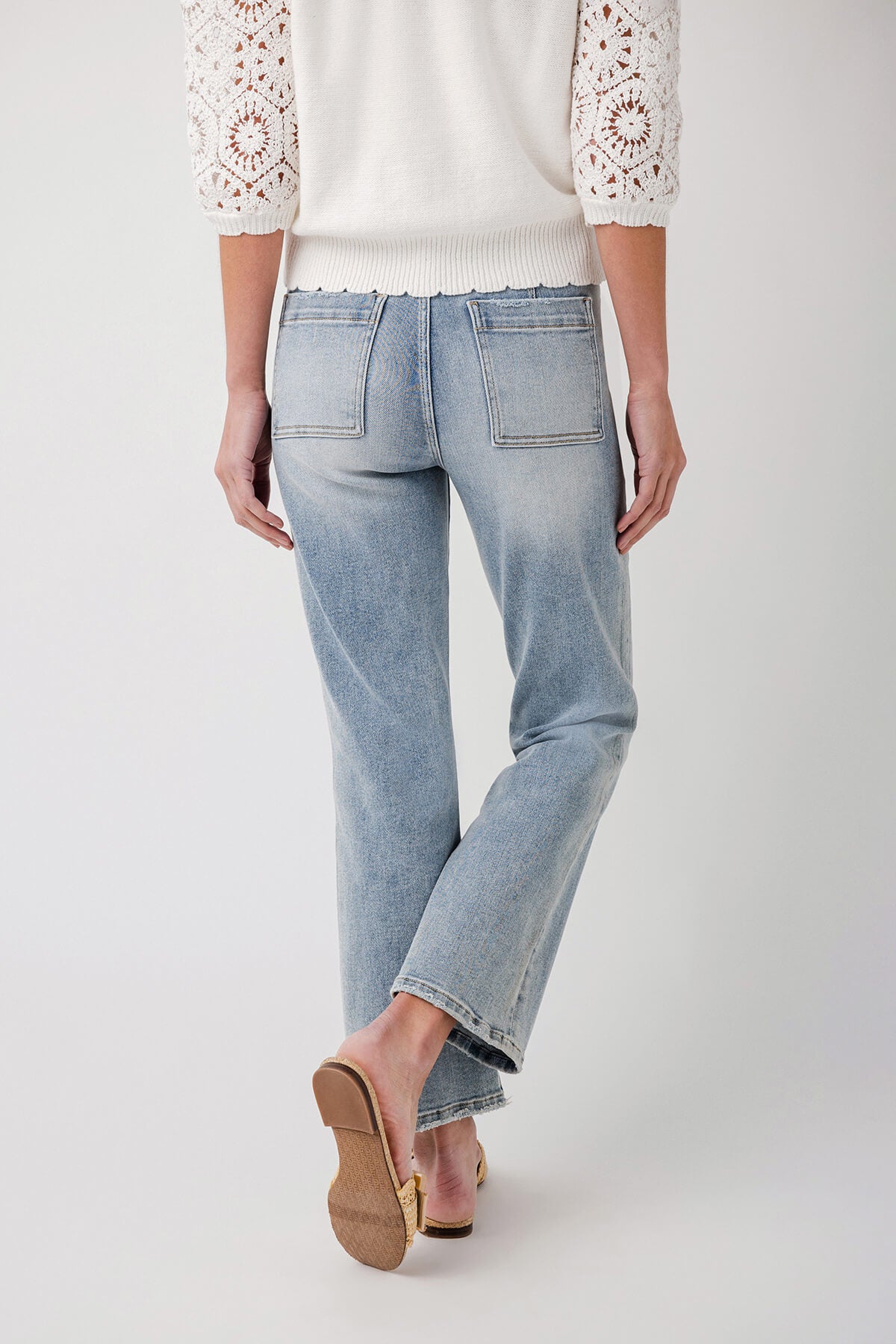 Light blue ankle flare jeans with button fly and stitched front patch pockets