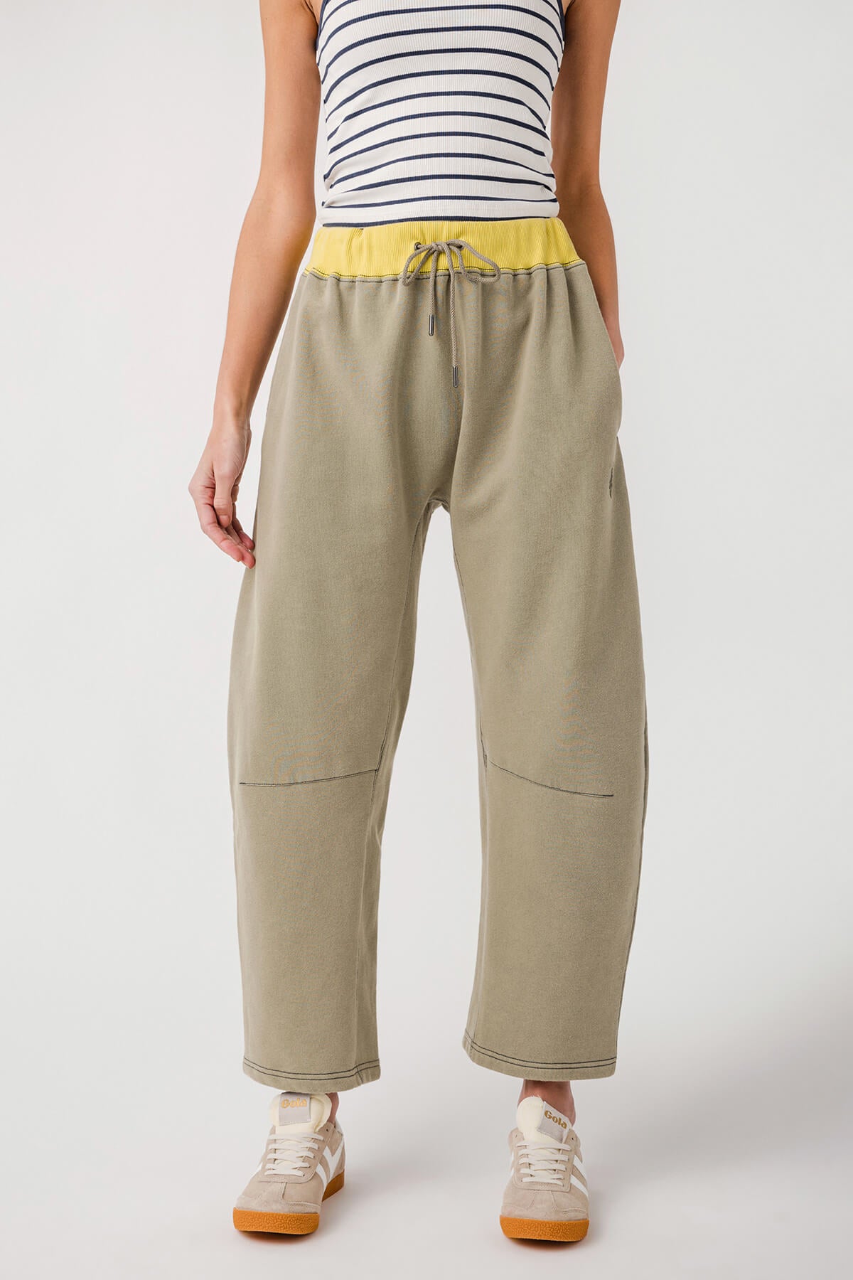 Sage green drawstring pants with elastic waistband and relaxed fit, side pockets