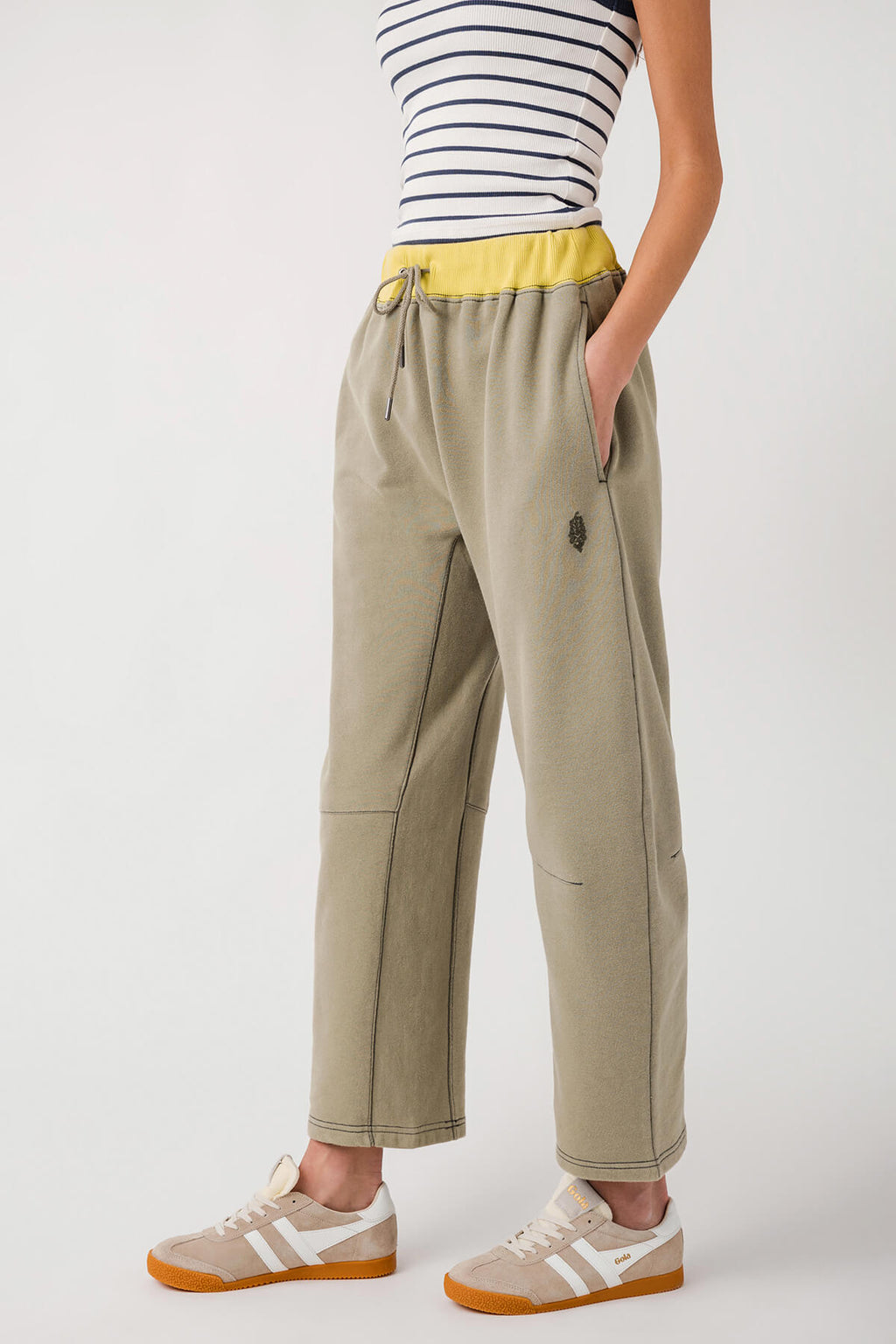 Sage green wide-leg pants with elastic waist and drawstring; stitched side seams