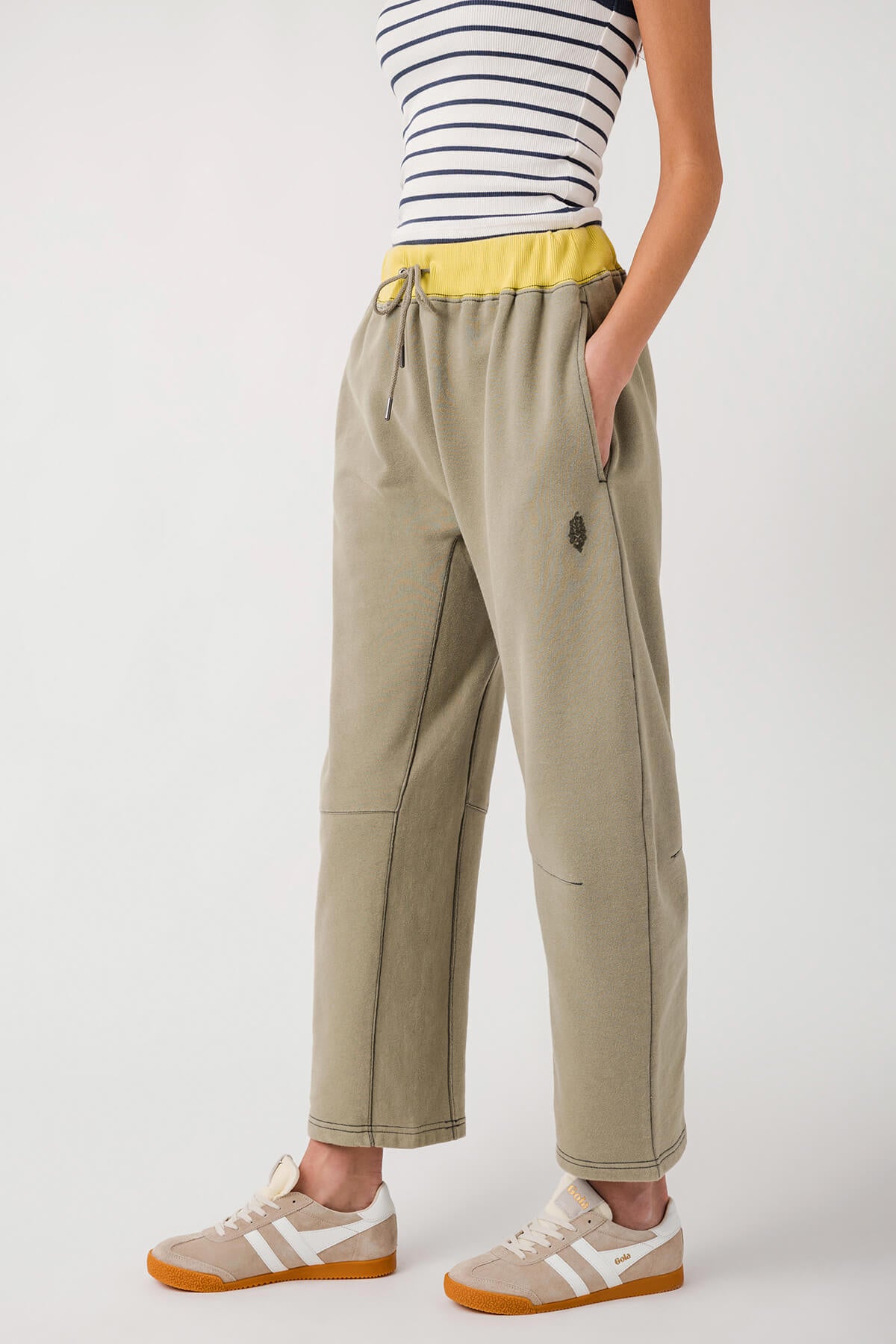 Sage green wide-leg pants with elastic waist and drawstring; stitched side seams