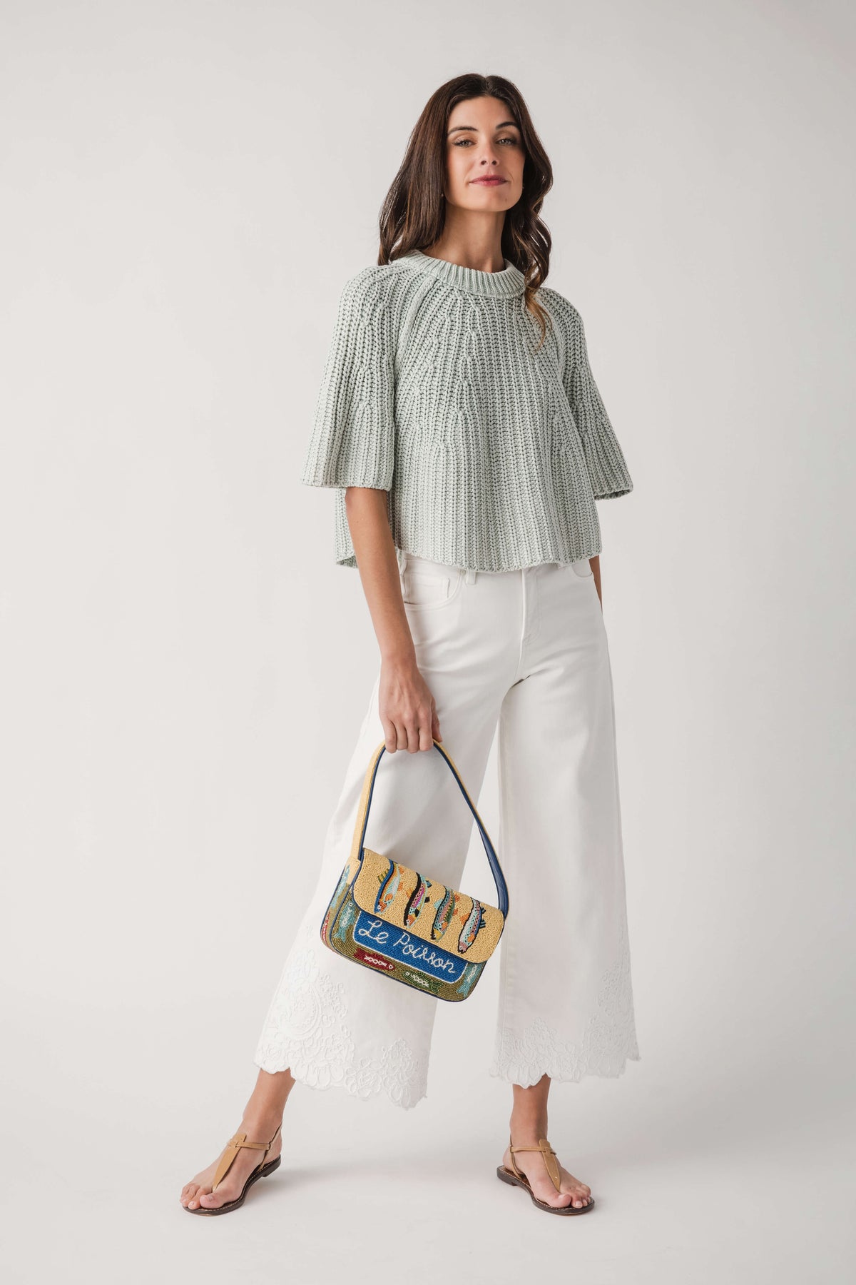 Cream high-rise crop pants with wide leg opening and lace-trimmed hem