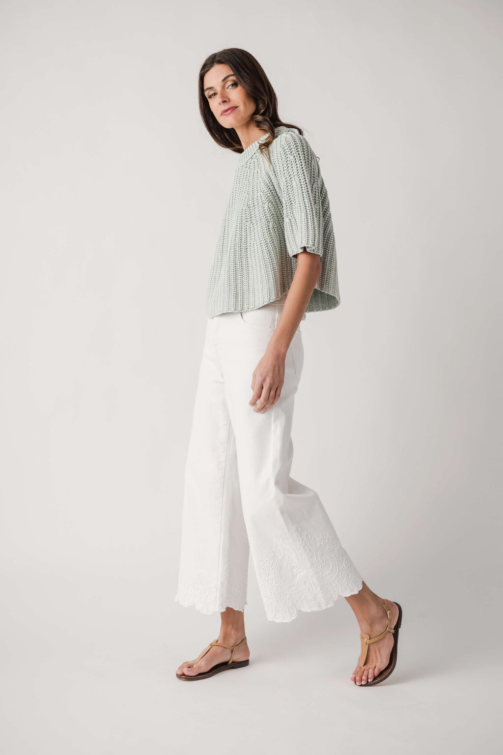 Cream high-rise crop wide-leg pants with lace hem detail and straight waistband
