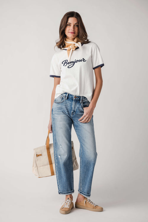White Bonjour T-shirt with navy trim and tied bow neck, with light-wash jeans