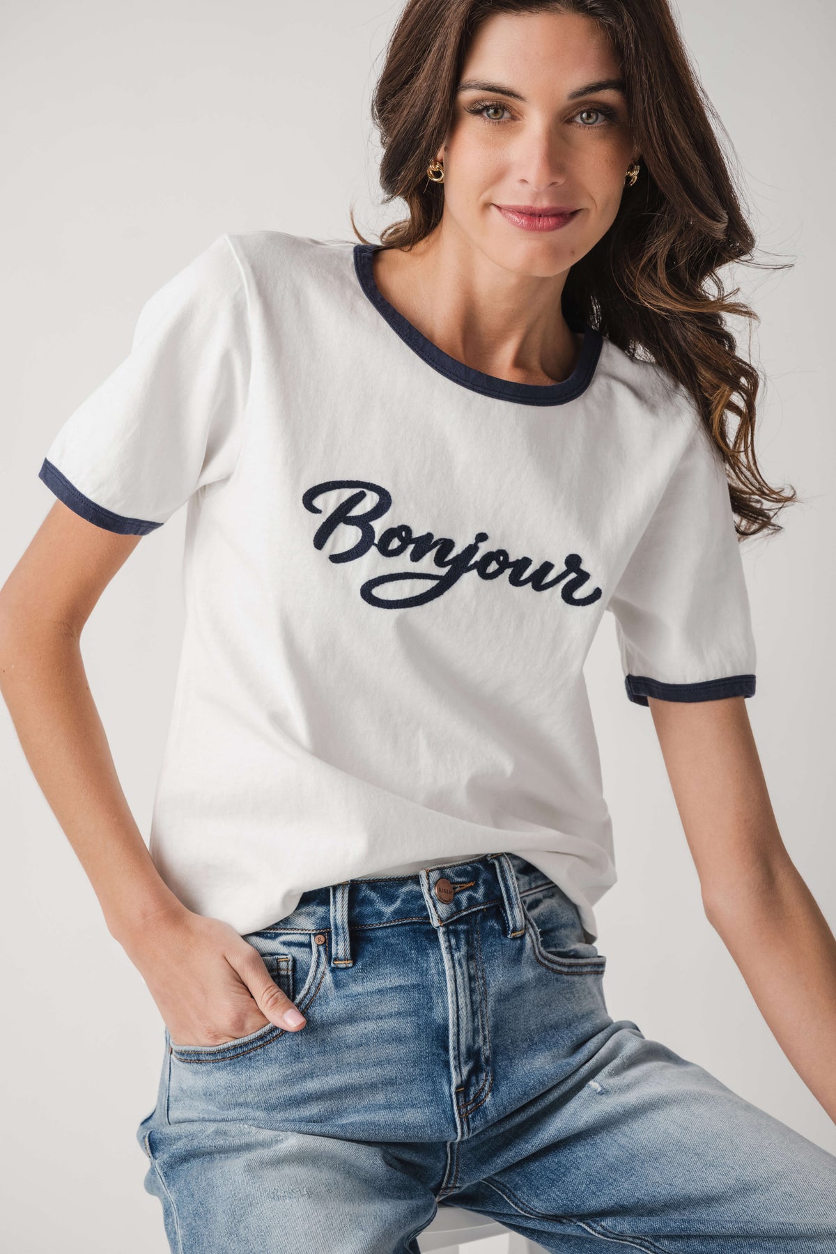 White Bonjour T-shirt with navy neck and sleeve trim, close-up front print
