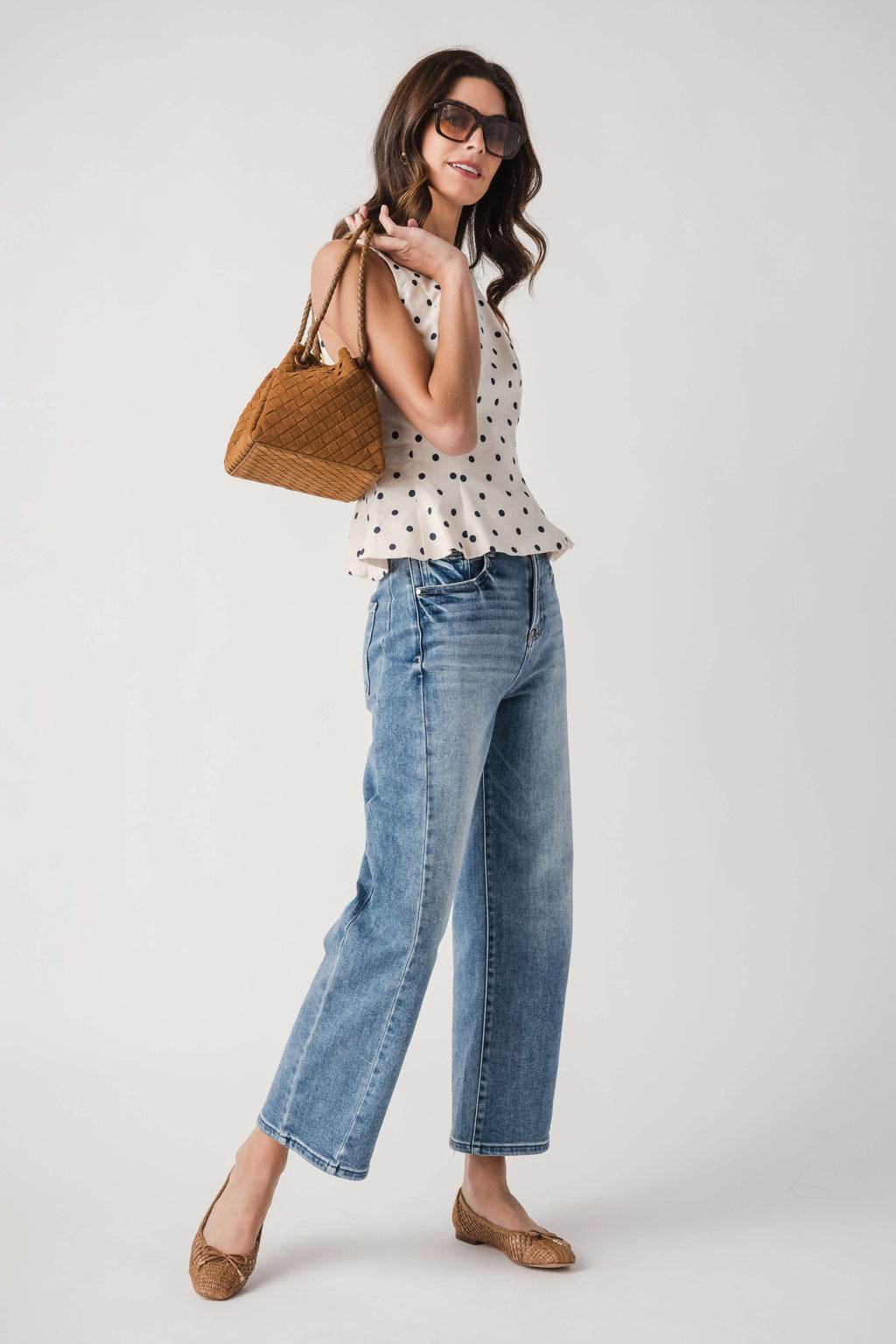 Cream polka dot sleeveless pleated peplum top, side view