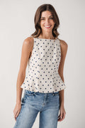 Cream polka dot sleeveless pleated peplum top with peplum hem