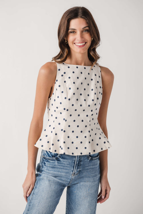 Cream polka dot sleeveless pleated peplum top with peplum hem