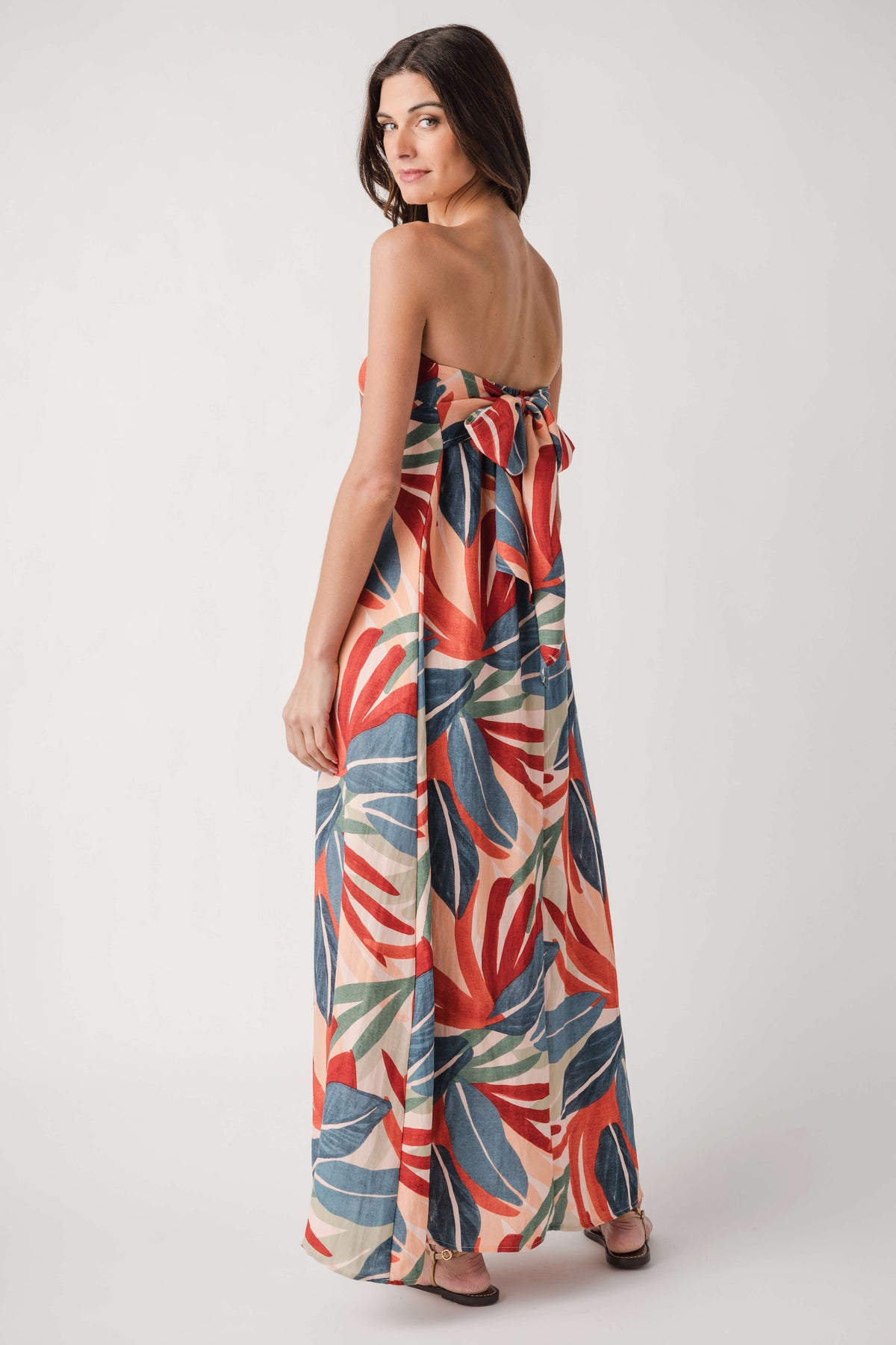 Strapless palm print maxi dress, orange blue green tropical leaf pattern; side view