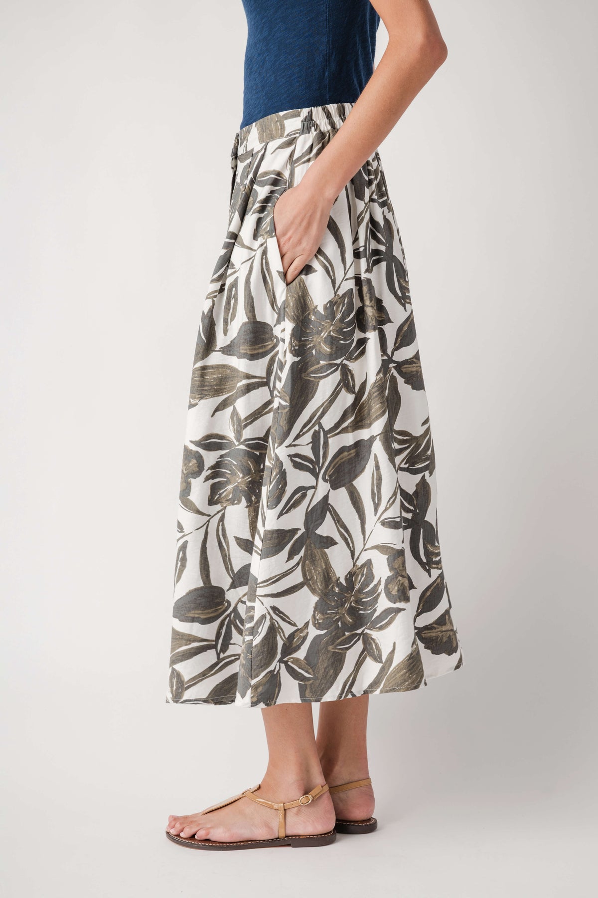 Leaf-print midi skirt with elastic waist, olive and cream, hand at side view