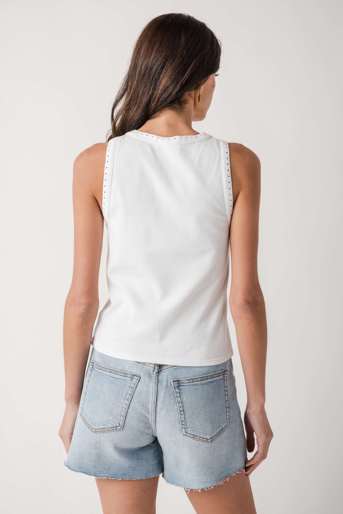 Back view of white ribbed sleeveless tank with eyelet-trim neckline