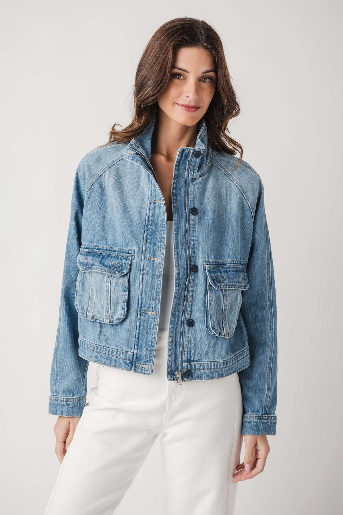 Light blue denim jacket with button-front closure and chest flap pockets
