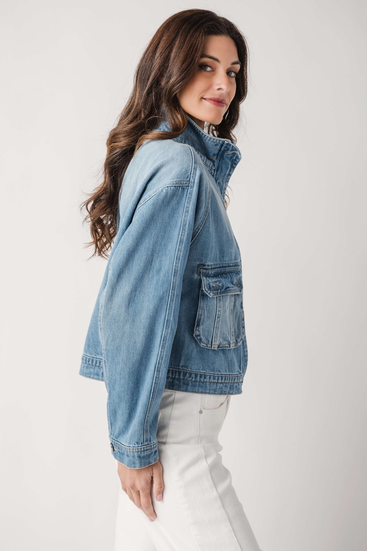 Light blue denim jacket side view with chest flap pocket and button-front placket
