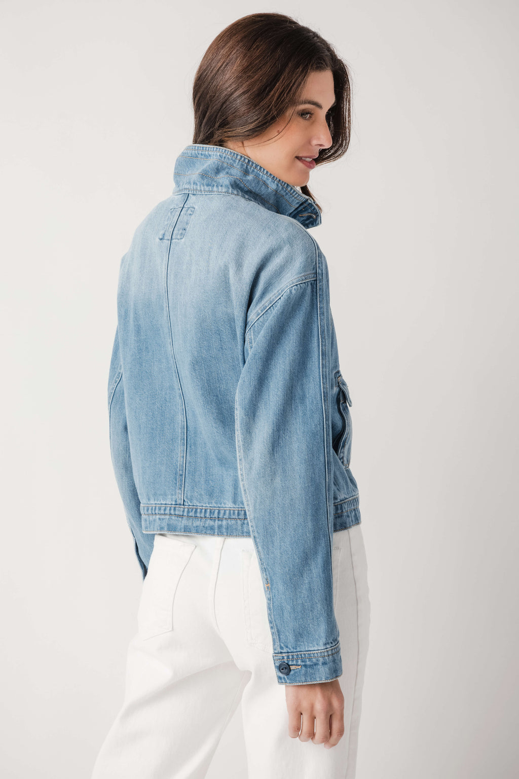 Light blue denim jacket back/side view with collar seam detail and button cuffs