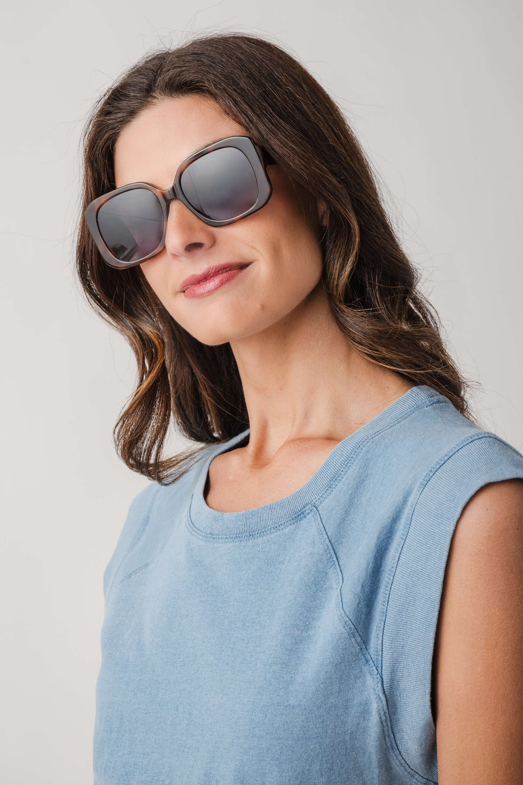 Brown tortoise sunglasses with dark lenses, wide square frames