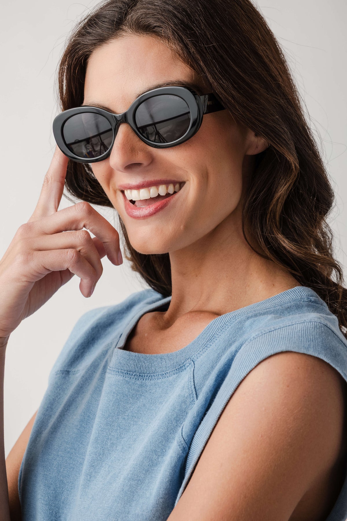 Freyrs Aria black round sunglasses with dark lenses, worn by model angled front view