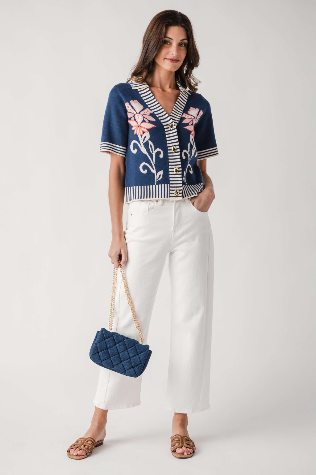Denim woven crossbody bag worn crossbody with gold chain strap and diamond weave