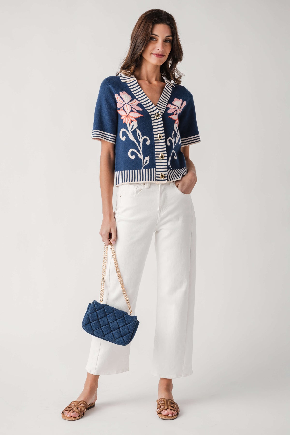 Denim woven crossbody bag worn crossbody with gold chain strap and diamond weave