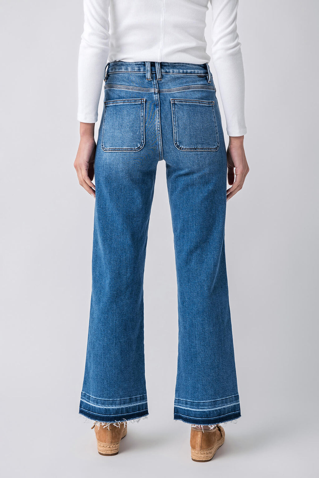 Medium blue high-rise straight jeans, back view, released hem at ankle