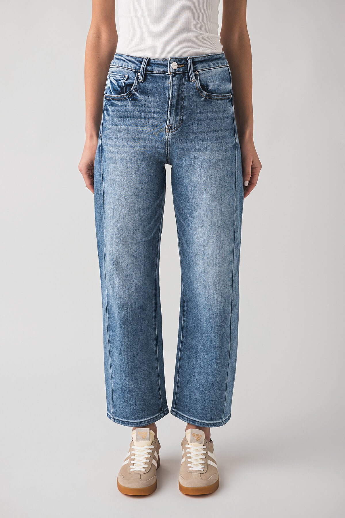 High-rise barrel jeans in blue wash with button-and-zip fly and wide barrel silhouette