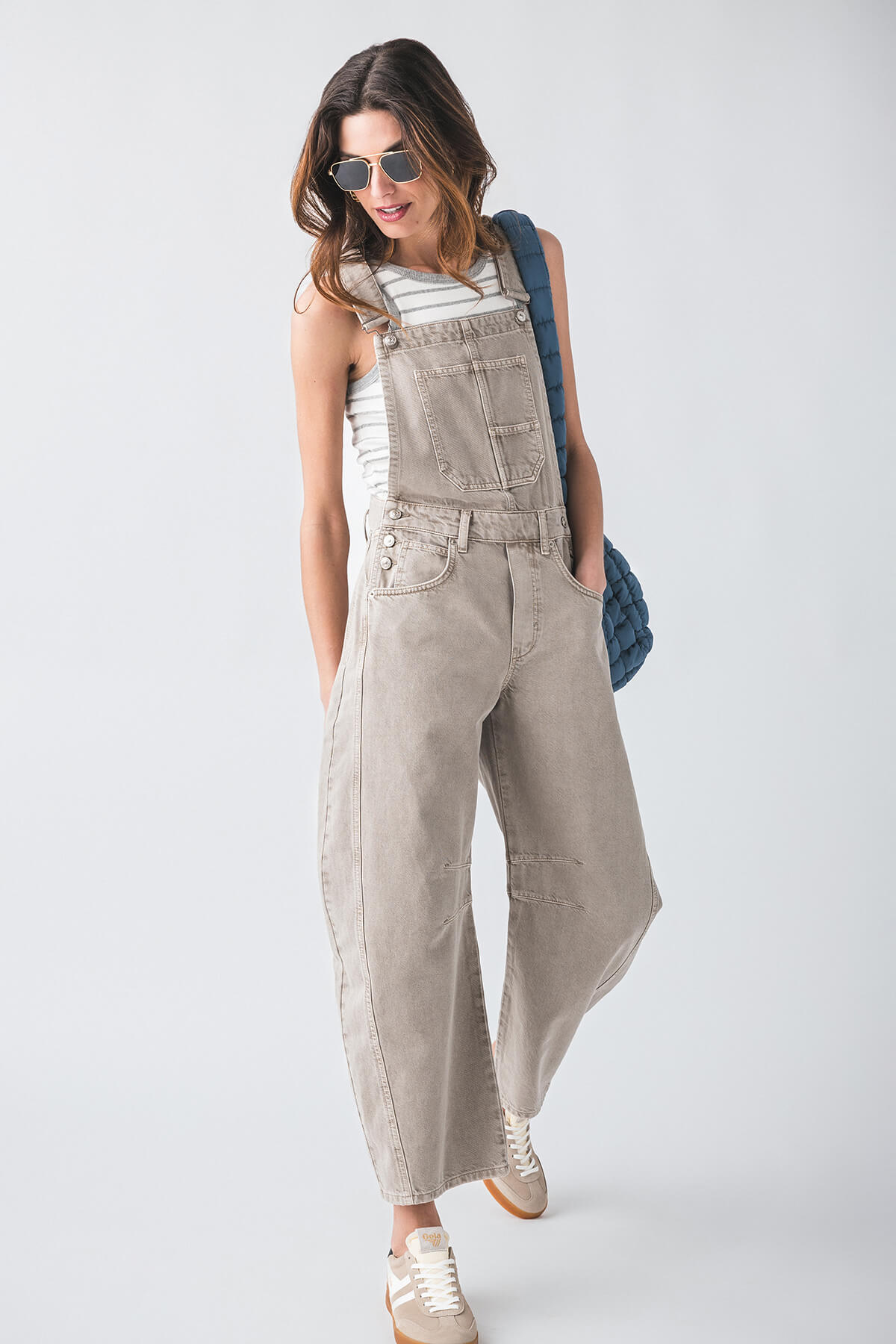 Taupe canvas overalls with chest pocket and side seams, relaxed fit, ankle length.