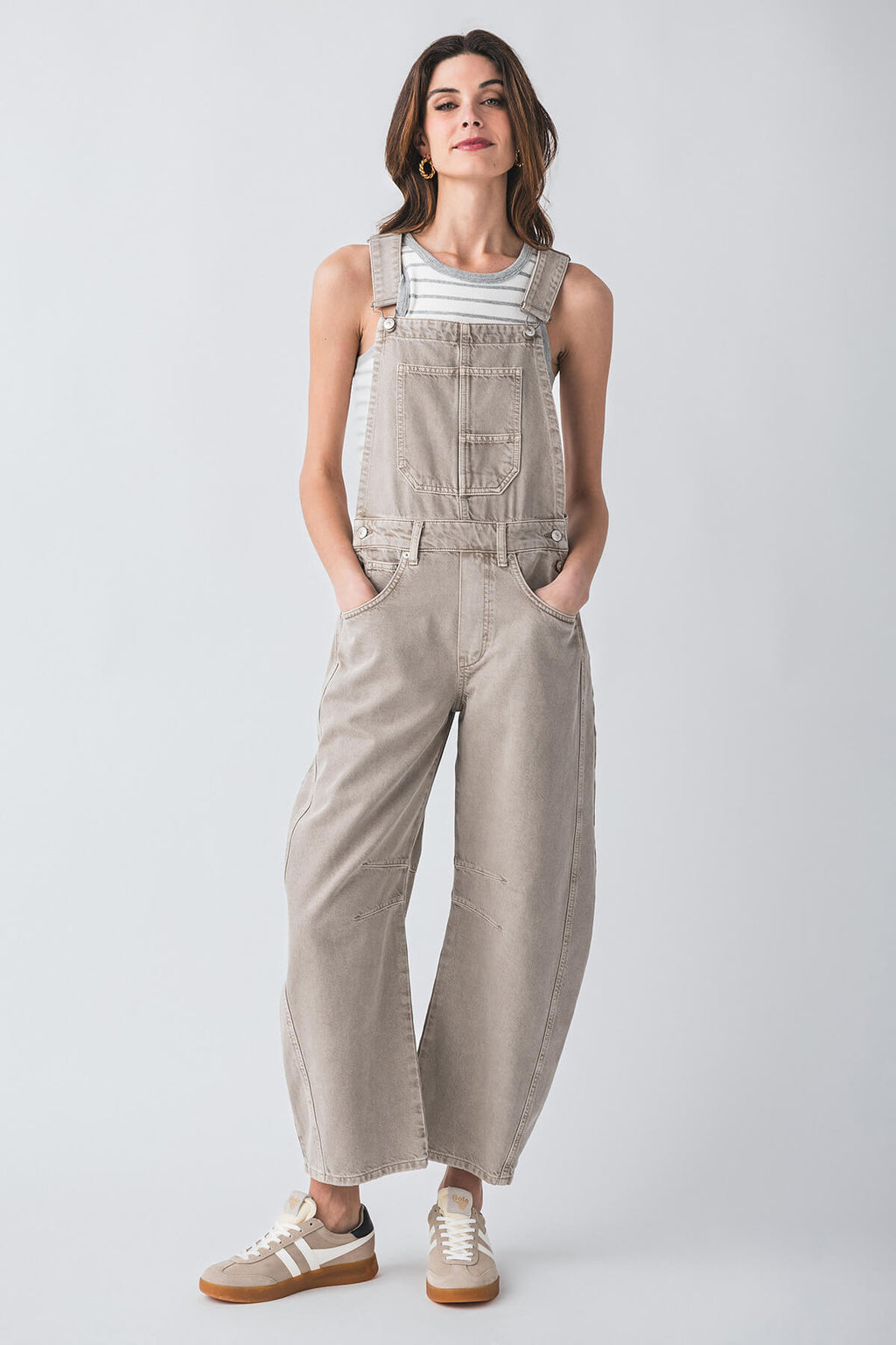 Light beige denim sleeveless overalls with bib front, chest pockets, and wide legs