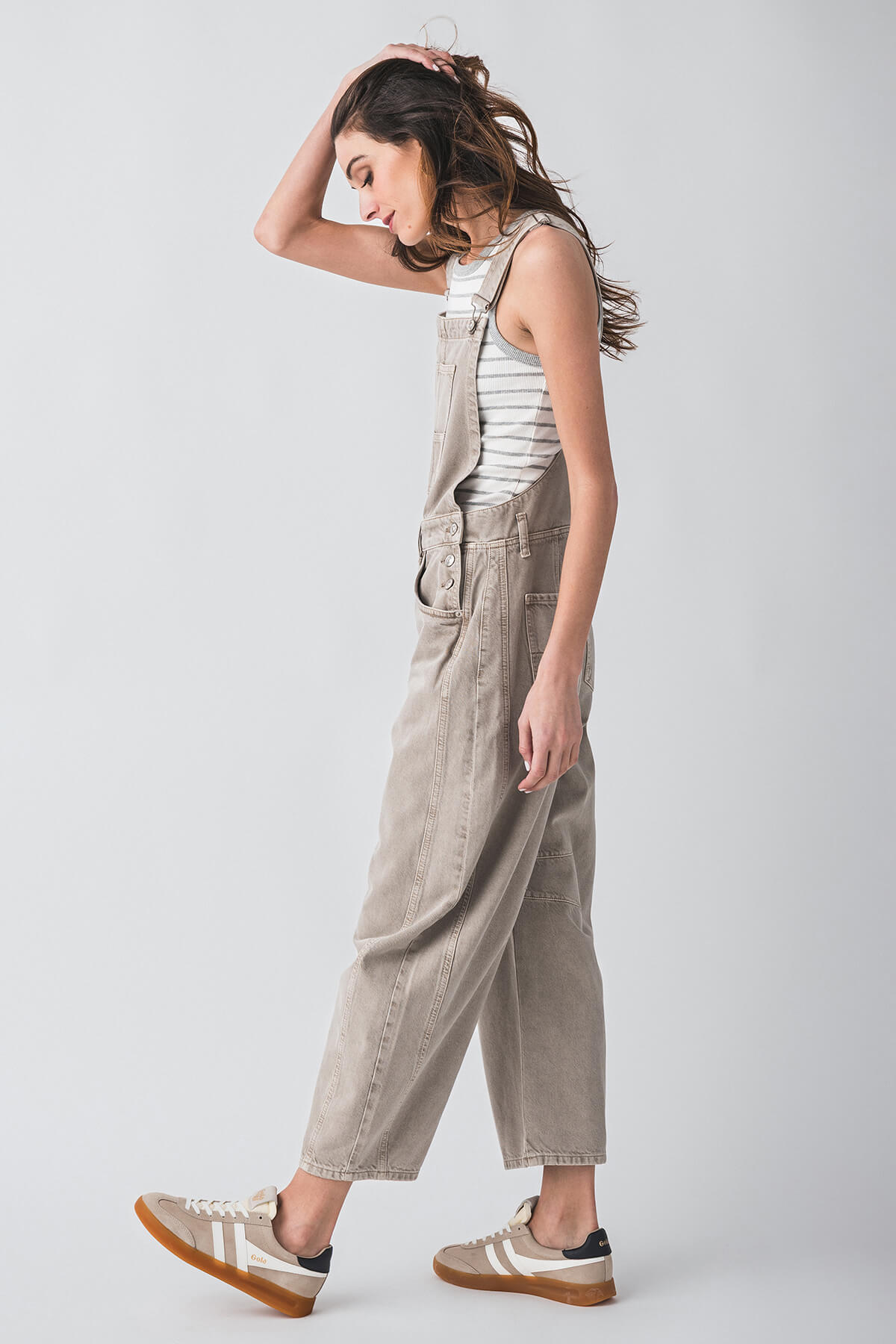 Light beige denim overalls with bib front, adjustable straps, and large front pockets