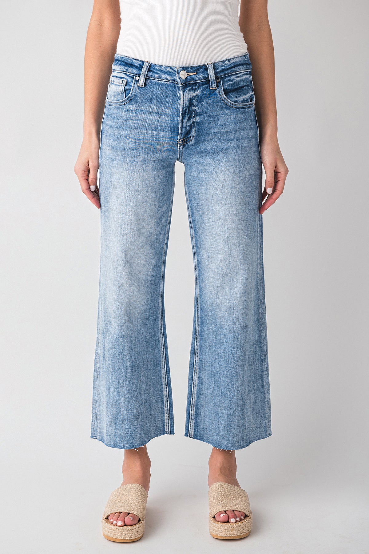 High-rise wide-leg light wash denim jeans with button fly and back yoke