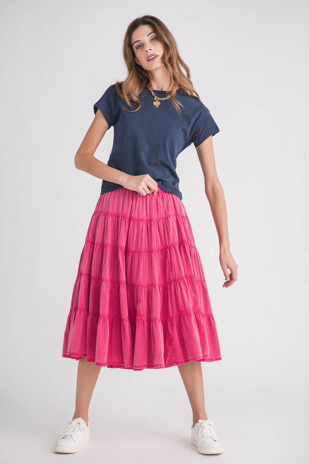 Navy modern slub tee with short sleeves and round neckline, paired with a pink tiered skirt