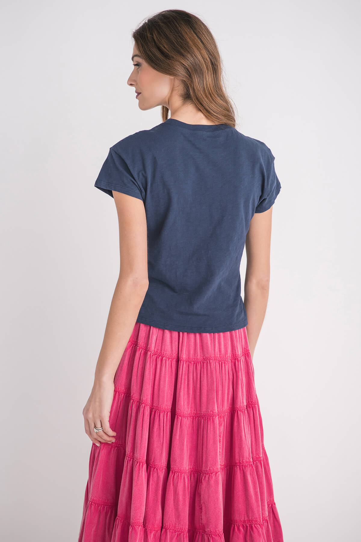 Navy modern slub tee with short sleeves and round neckline, worn with a tiered skirt