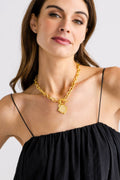 Gold coin pendant necklace with textured round front on curb link chain